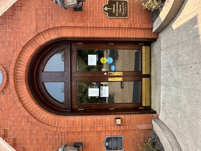 Refinished arched entry door in a rich dark stain